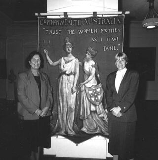 Women members of parliament (l-r) Senator Margaret Reynolds and Ros Kelly with 1908 Women's banner - Old Parliament House Canberra, 1988